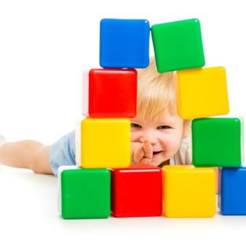 boys is playing with building blocks and cubes happily